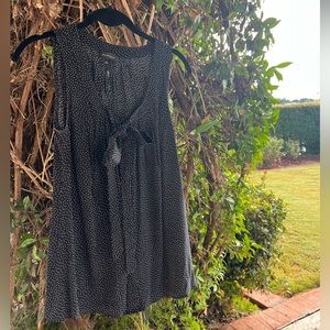 Black top with white polka dots and a bow